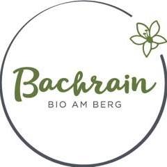 Logo Bachrein, grüner Kreis mit Schriftzug und Blume rechts oben